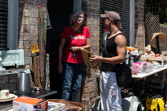 Manis talking to Julia Manley, left, at her Lilyfield stall on the Garage Sale Trail.