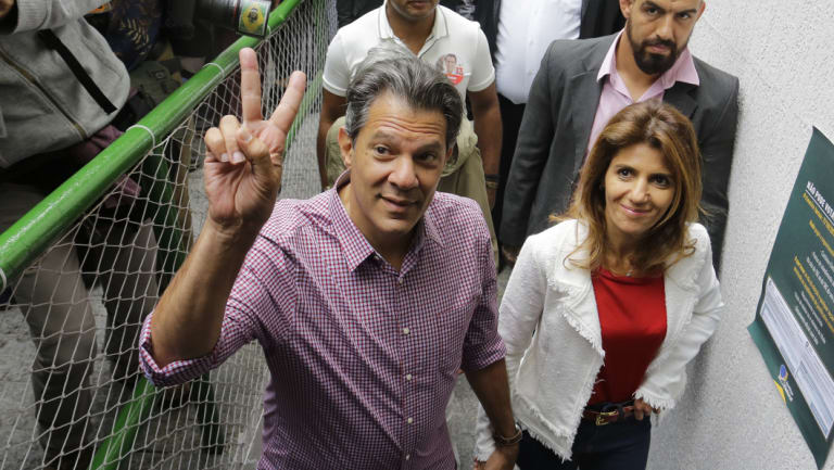 Workers' Party presidential candidate and wife Ana Estela arrive to cast their vote in Sao Paulo.