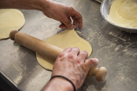Sourdough pita is rolled out for every order. 