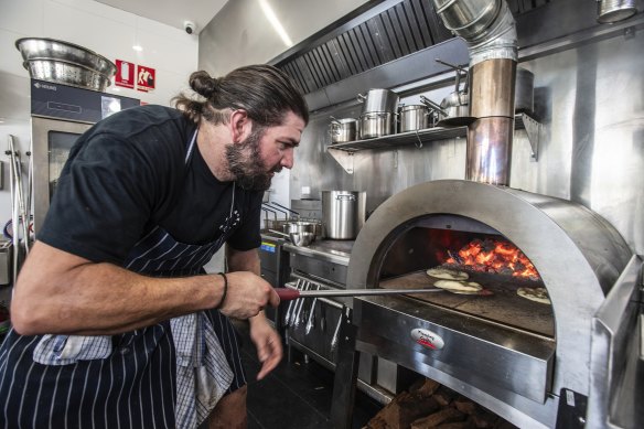 Cassimatis cooking the sourdough pitas in the wood-fire oven. 