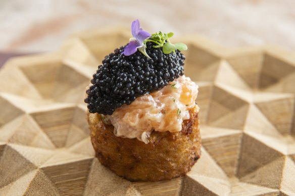 Deep-fried potato topped with caviar and salmon tartare.