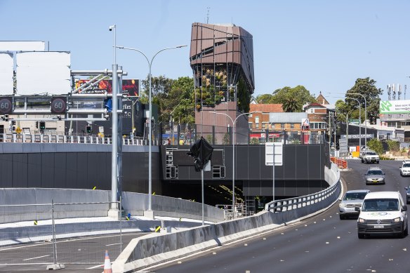 An emissions stack towers over a tunnel entrance and exit to the  Rozelle interchange at Iron Cove.