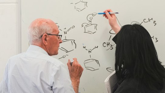 Professor Richard Robson (left) with a student during a lesson at the University of Melbourne on Thursday after being awarded the Nobel Prize in Chemistry.