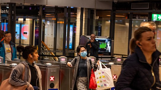 Commuters exiting Town Hall station on Tuesday morning after new public transport restrictions were imposed.