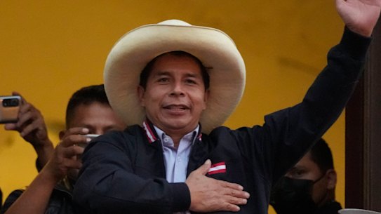 Presidential candidate Pedro Castillo waves to supporters celebrating partial election results that show him leading over Keiko Fujimori, at his campaign headquarters in Lima, Peru.