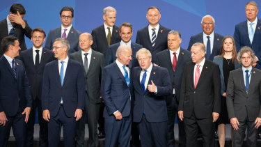 British Prime Minister Boris Johnson stands beside US President Joe Biden and other world leaders posing for a family photo during the Nato summit.