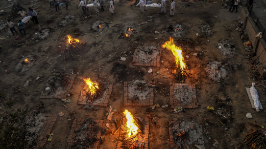 New bodies arrive at a mass cremation site in Delhi, India, April 23, 2021. US government administration officials are coming under increasing pressure to lift restrictions on exports of supplies that vaccine makers in India say they need to expand production amid a devastating surge in COVID-19 deaths there. 