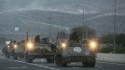 Israeli armored personnel carriers move in formation near the border with Lebanon.