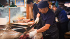 A wholesaler cuts a tuna at Tsukiji, the famed wholesale seafood market in Tokyo, on the day before its closure.