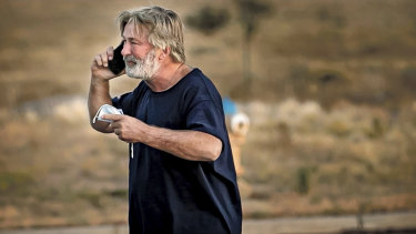 Alec Baldwin speaks on the phone in the parking lot outside the Santa Fe County Sheriff’s Office in Santa Fe, New Mexico, after he was questioned about a shooting on the set of the film Rust.