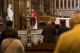 Father Don Richardson celebrates Mass at St Mary’s Cathedral in October.