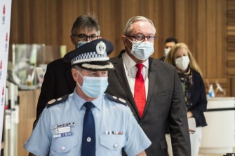Health Minister Brad Hazzard, NSW Health’s Dr Jeremy McAnulty and NSW Police Deputy Commissioner Michael Willing on Saturday.