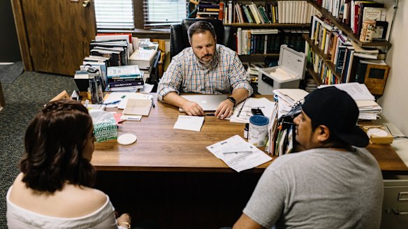 The Reverend Trey Hegar meets Felipe Clamos, right, one of 32 cement plant workers arrested by immigration authorities in Mount Pleasant.