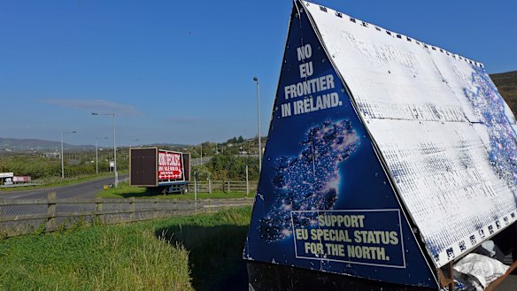 A sign in a parking lot of a cemetery reads: "No EU border in Ireland" near Carrickcarnan, Ireland.
