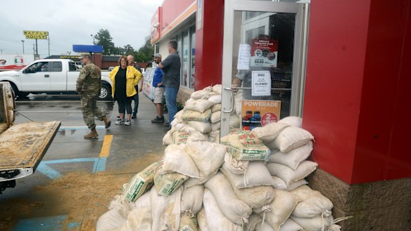 Staff at a Circle K gas station on East New Bern prepared for severe flooding from Florence with sandbags piled near the entrance on Saturday.