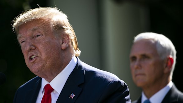 US President Donald Trump, left, speaks while US Vice-President Mike Pence listens during a ceremony for the establishment of a US Space Command.