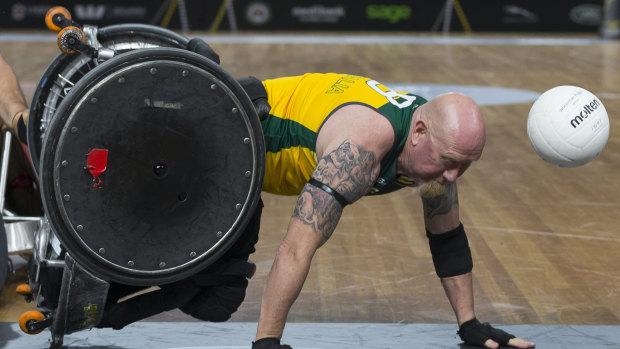 Jeff Wright of Australia goes down during the Wheelchair Rugby event between Australia and New Zealand at the Invictus Games, in Sydney.