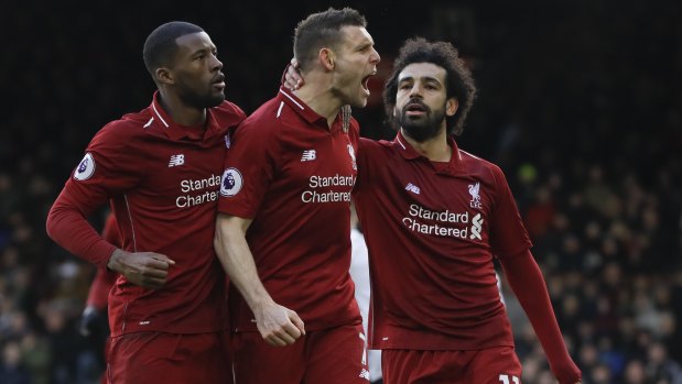 A crucial win: Liverpool's James Milner (centre) celebrates a goal in the March win over Fulham.