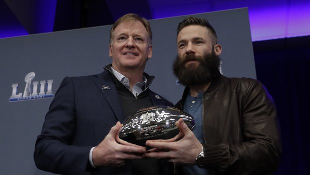 Roger Goodel poses with Edelman and the MVP trophy.