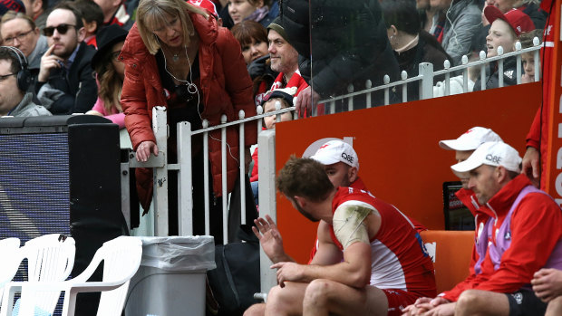 Alex Johnson's mother checks on him after he came off the ground with his injury.