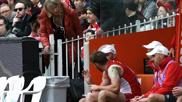 Alex Johnson's mother checks on him after he came off the ground with his injury.