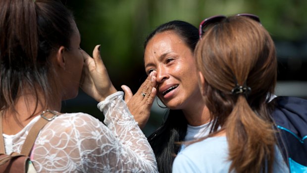 Relatives of 68 people killed in the fire wait for officials to turn over the remains of their loved ones. 