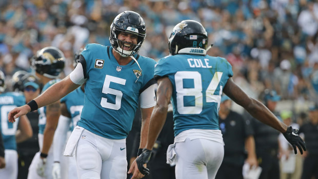 Triumph: Jacksonville quarterback Blake Bortles (left) celebrates a touchdown pass to wide receiver Keelan Cole.