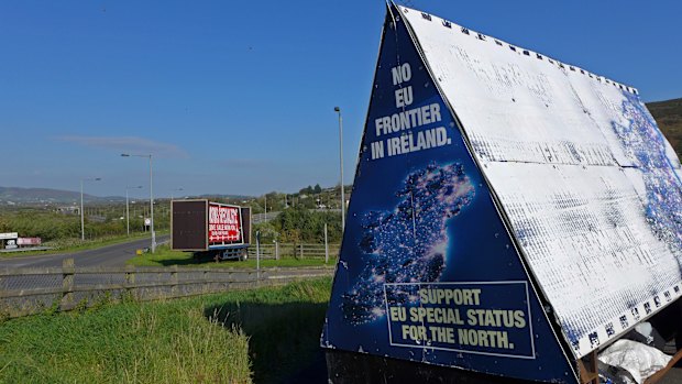 A sign in a parking lot of a cemetery reads: "No EU border in Ireland" near Carrickcarnan, Ireland.