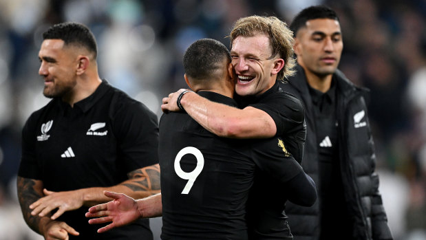 Damian McKenzie and Aaron Smith celebrate a comprehensive New Zealand win in Paris.