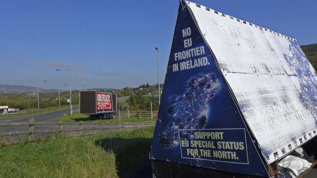 A sign in a parking lot of a cemetery reads: "No EU border in Ireland" near Carrickcarnan, Ireland.