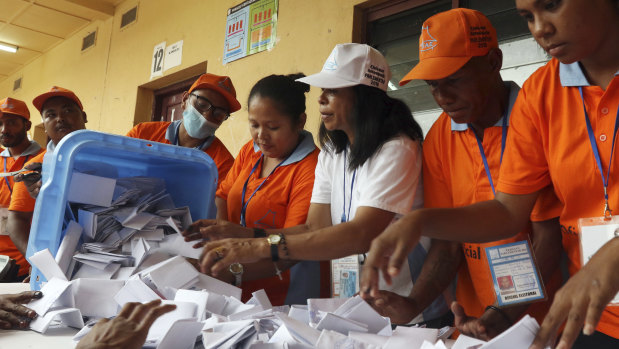 Electoral workers open a ballot box during the vote counting at a polling station following the parliamentary election in Dili, East Timor on May 12.