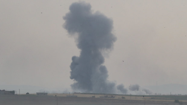 Smoke rises over the Syrian town of Tel Abyad, as seen from the Turkish border town of Akcakale.