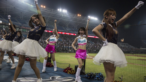  Cheerleaders dance during a baseball game, at the Taoyuan International Baseball Stadium in Taoyuan City, Taiwan. 