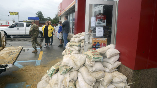 Staff at a Circle K gas station on East New Bern prepared for severe flooding from Florence with sandbags piled near the entrance on Saturday.