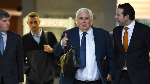 Businessman Clive Palmer (centre) leaves the District Court in Brisbane on July 23.