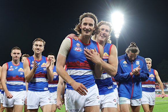 Jedd Busslinger celebrates his first win as an AFL player.