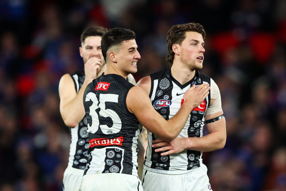 Nick Daicos and Patrick Lipinski of Collingwood celebrate a goal.