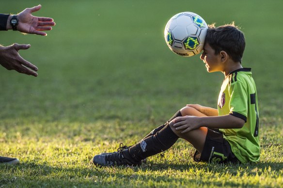 Alex Nitsas, 7, being taught proper heading technique to prepare him in case it comes up in a match.