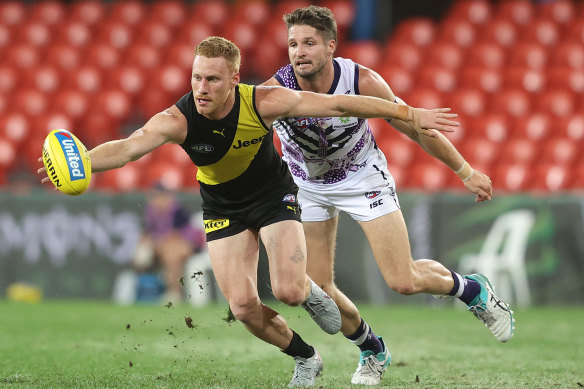 Nick Vlastuin gathers the ball ahead of Fremantle's Jesse Hogan.