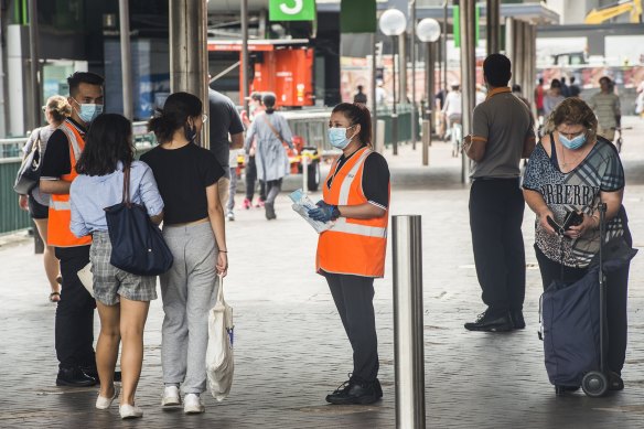 Masks being handed out at Circular Quay on Monday.