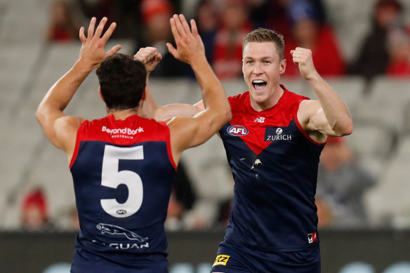 Christian Petracca, left, and Tom McDonald, right, celebrate a goal. 