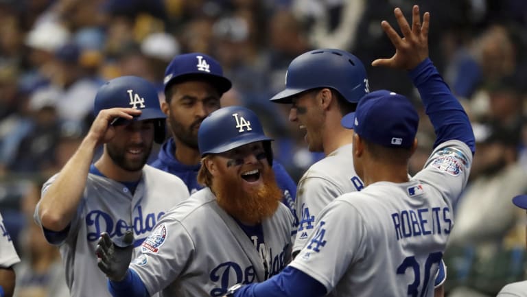 Justin Turner is congratulated by Dodgers manager Dave Roberts.