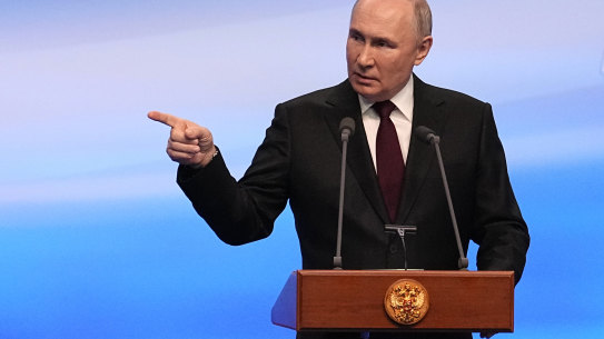 Russian President Vladimir Putin gestures while speaking on a visit to his campaign headquarters on Monday.