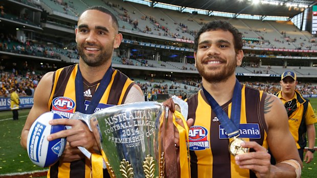 Shaun Burgoyne and Cyril Rioli celebrate the 2014 premiership win by Hawthorn.