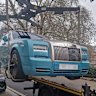 A blue Rolls-Royce is removed from Grosvenor Square in Mayfair, London.