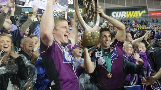 Brett Finch hoists the Provan-Summons trophy with Billy Slater after helping the Storm to victory over Parramatta in the 2009 grand final.