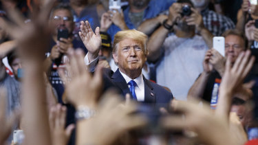 President Donald Trump waves to the cheering crowd as he arrives for a political rally in Wilkes Barre, Pennsylvania.