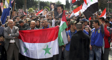 In this photo released by the official government news agency, Syrians in the costal port city of Tartus protest against US President Donald Trump's move to recognise Israeli sovereignty over the occupied Golan Heights.