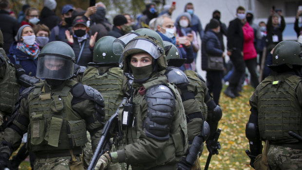 Armed police block demonstrators during an opposition rally to protest the official presidential election results in Minsk, Belarus.