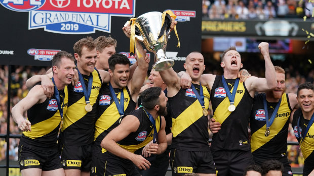 The Tigers celebrate with the premiership cup.